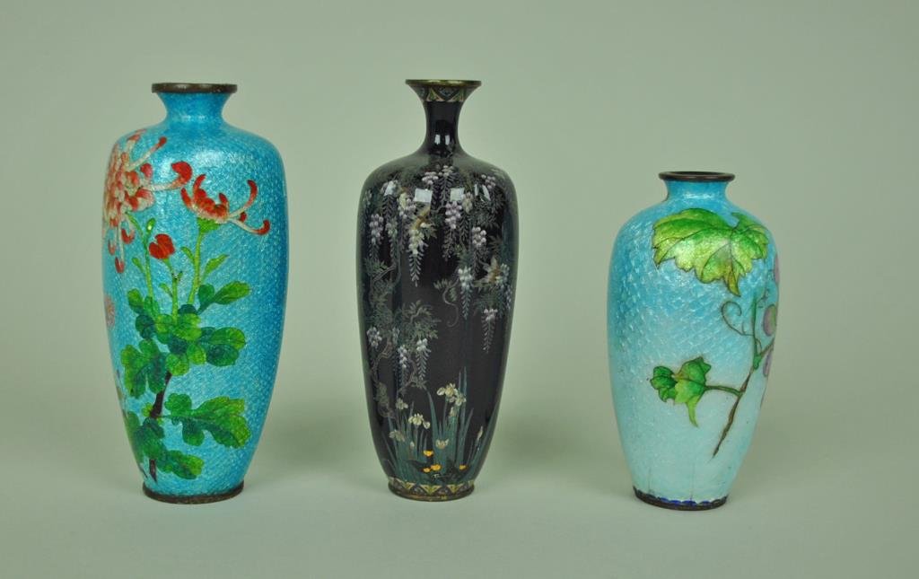 (3) JAPANESE CLOISONNE CABINET VASES: Meiji (1868-1912), comprising a 6" black ground vase in floral design (minor dings), and 2 vases with fish scale ground including a 6" in floral motif and a 5" in grape motif (grape vase with craze li
