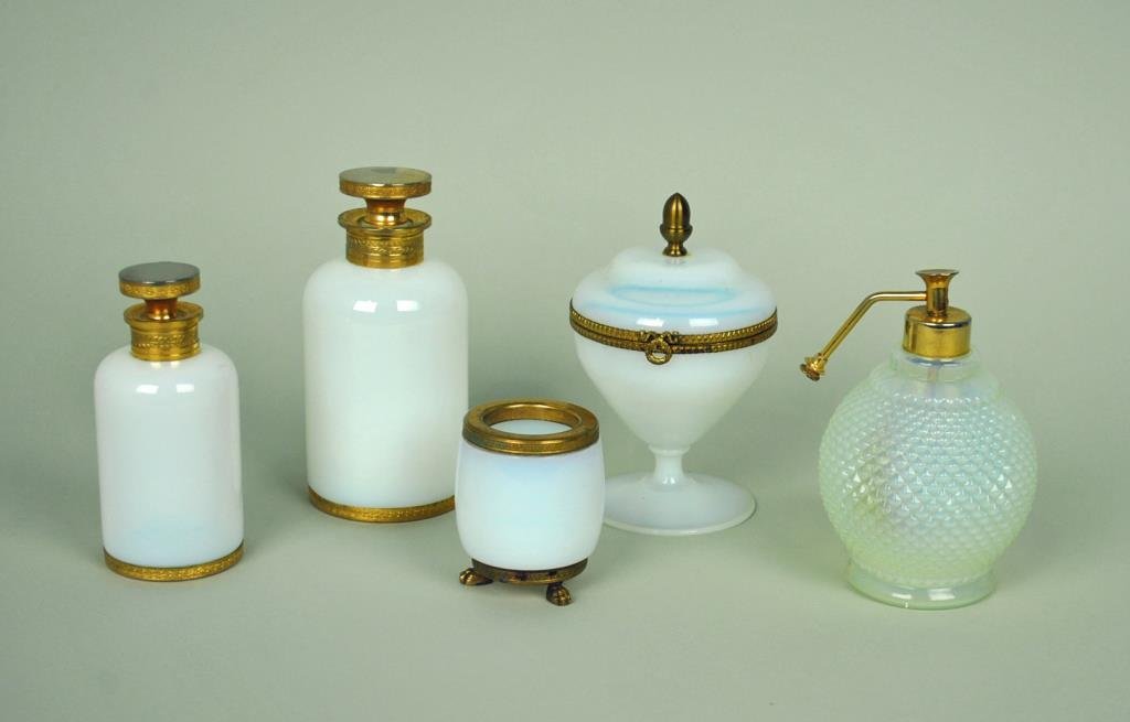 (5) FRENCH OPALINE VANITY ITEMS: comprising a 3-piece bronze mounted dresser set, (wear to dore at top of lids), a brass mounted dresser jar with pedestal base (small amt of residue at finial attachment), and an atomizer perfume bott