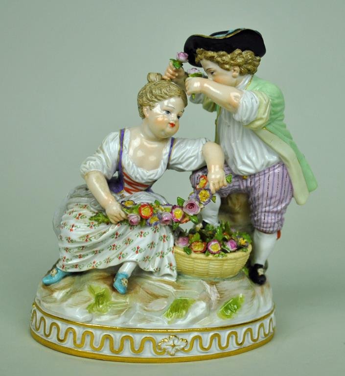 MEISSEN FIGURAL GROUP: two children gardeners, underglaze blue crossed sword mark, inscribed F 93, impressed 23, 6in., minor leaf chips