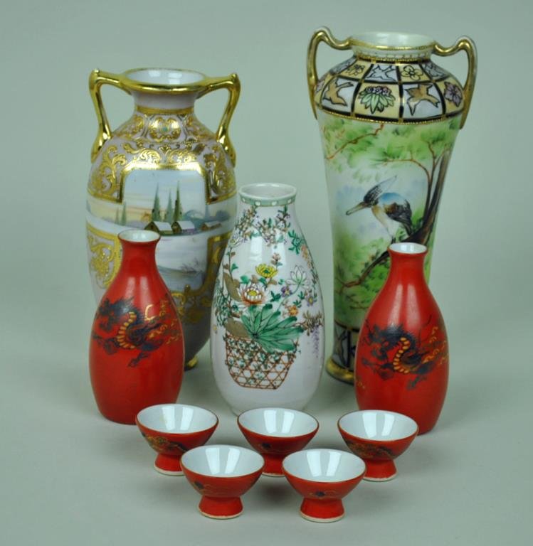 (10) PIECE JAPANESE GROUP: including a 10" Nippon vase in bird motif, an 8.5" Nippon scenic vase, a 6.5" unmarked enamel decorated floral vase, and a 7-piece silver overlay sake set