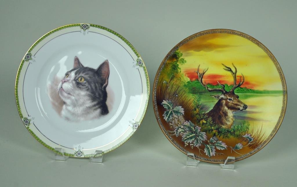 (2) NIPPON & NORITAKE ANIMAL PORTRAIT PLATES: including a Nippon transfer & painted buck plaque with embossed vine motif (minor wear and small abrasion to one leaf), and a Noritake transfer decorated plate with cat portrait