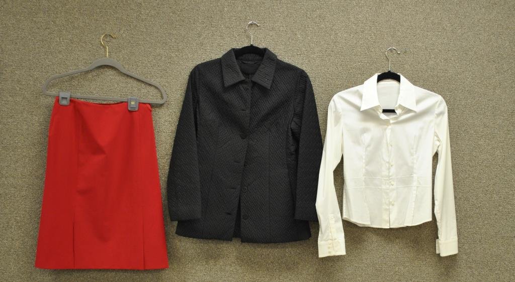 6-PIECE PRADA CLOTHING GROUP: including a black nylon jacket, length 26in., a white button down shirt, a navy blue and a red 90% polyester skirts, both 24in., a black wool/silk blend skirt, 25in., and a red wool skirt, 26in., all