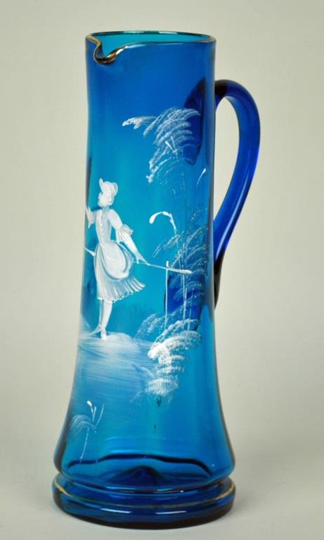 MARY GREGORY STYLE HAND BLOWN PITCHER: blue with white enamel decoration, applied handle, gilt trim, minor gilt wear, 13in.