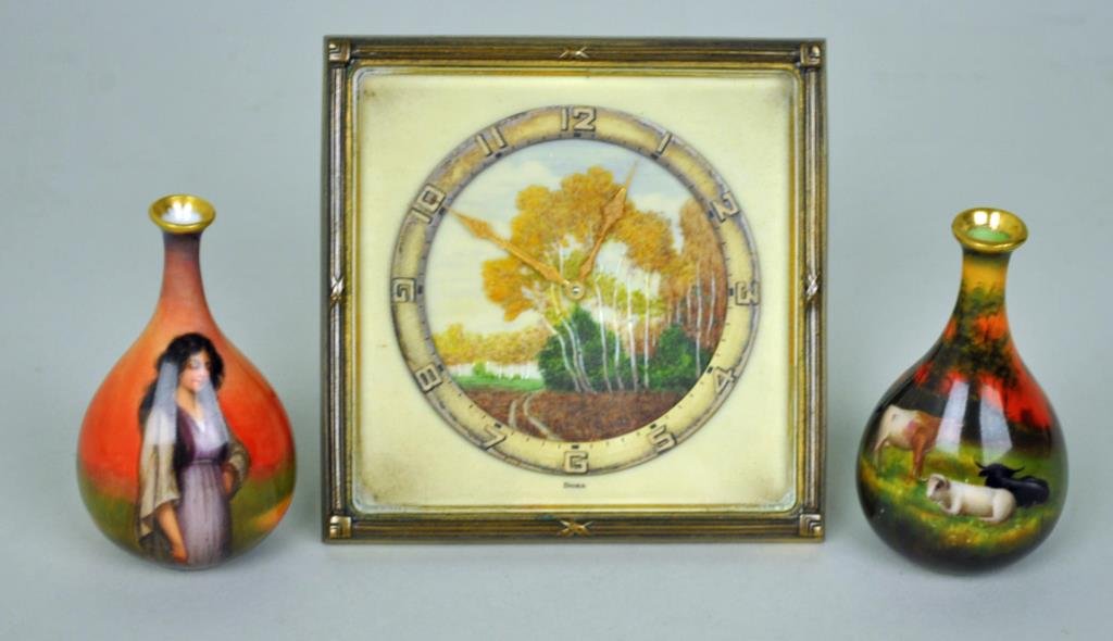 3-PIECE HAND PAINTED MINIATURE GROUP: including 2 German artist signed bud vases, one stamped Luscian Ware depicting a peasant girl, the other stamped Duerer Ware depicting cows in a landscape, each 3.5in., and a deco Doxa Swiss clock wit