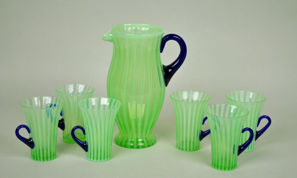 GREEN OPALESCENT RIBBED LEMONADE SET: possibly Fry, comprising a 10" pitcher and six 4.5" glasses (one glass with rim chip), applied blue handles