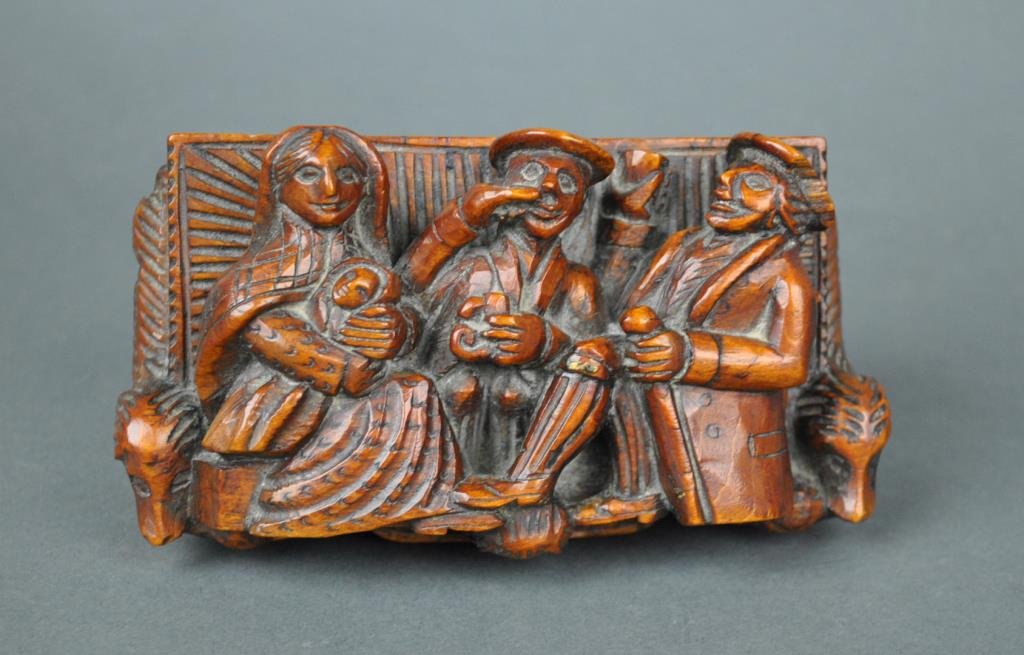 GEORGE III CARVED FIGURAL SNUFF BOX: Scotland, early 19thC., the hinged box carved in high relief with characters from Robert Burn's poem 'Tam O'Shanter', depicting Tam, Souter Johnny and the landlord's wife and child, the base with recu