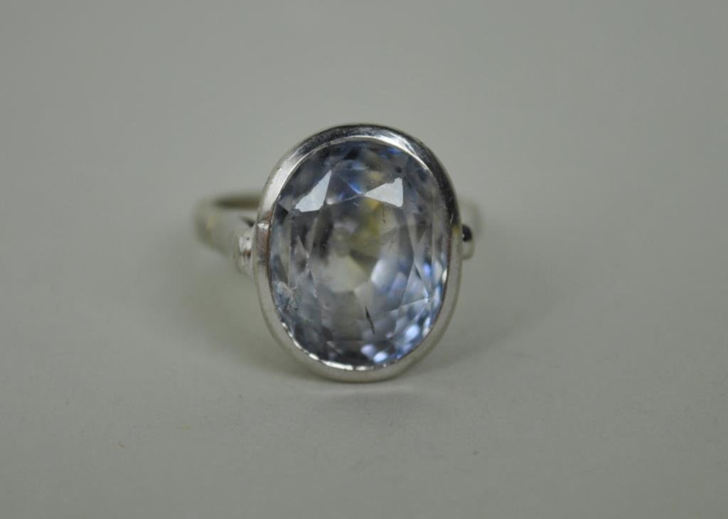 ART DECO GOLD & SAPPHIRE RING: comprising a bezel set sapphire stone approx. 14x11x11mm (13.5ct), small chip and minor abraded surface, some inclusions, white gold setting stamped 14K, size 6.25, 8.8gms., Estate Collection
