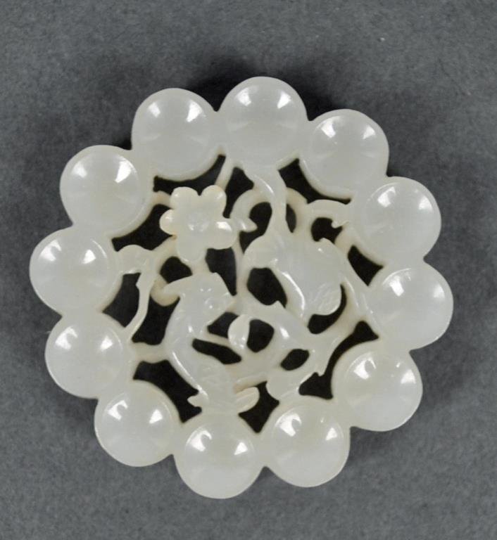 CHINESE CARVED WHITE JADE PIERCED DISC: 19th/20thC., having 12 cup-shaped outer discs, a pierced center dipicting a cat, a flower and vines, 1.75in.