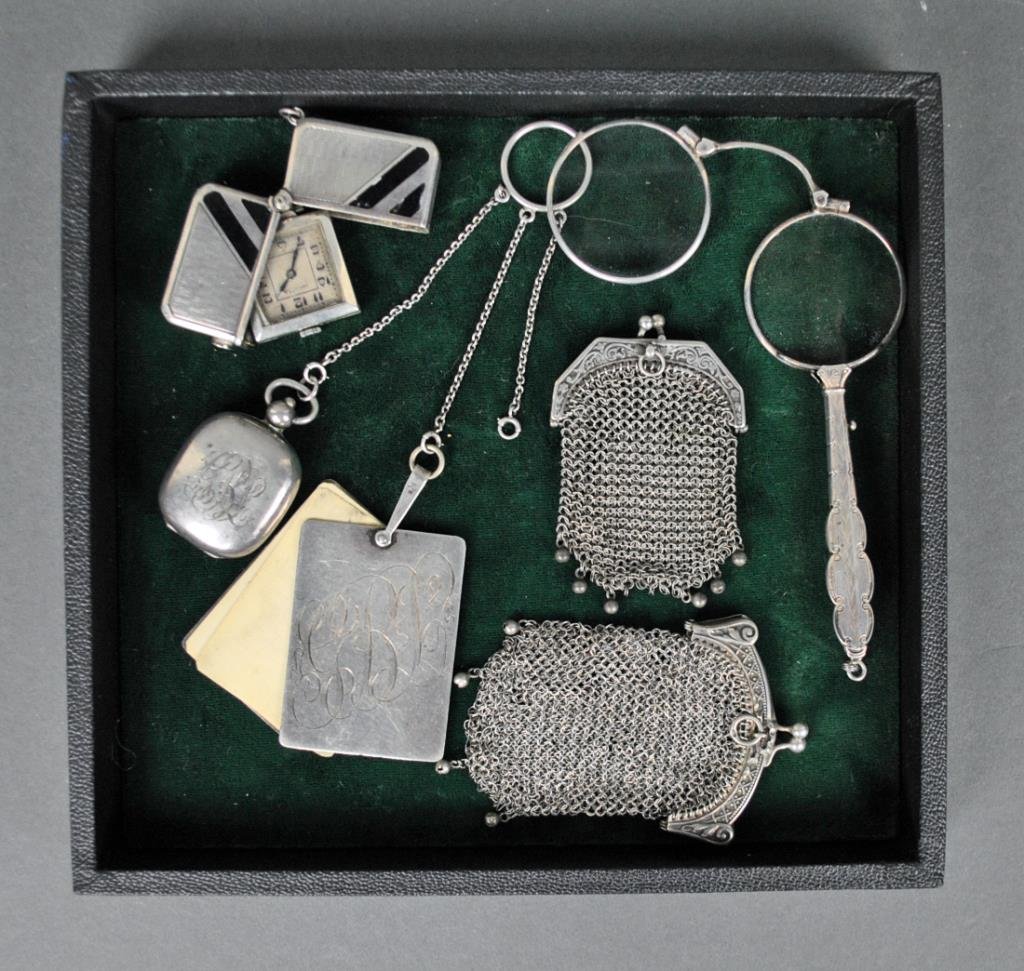 LADIES SILVER OBJECTS GROUP: including a 3-chain chatelaine ring suspending a celluloid sheet notebook and a coin holder, a lorgnette, an Invicta Brevete travel clock with black enameling, all marked Sterling or 935, and 2 mesh c
