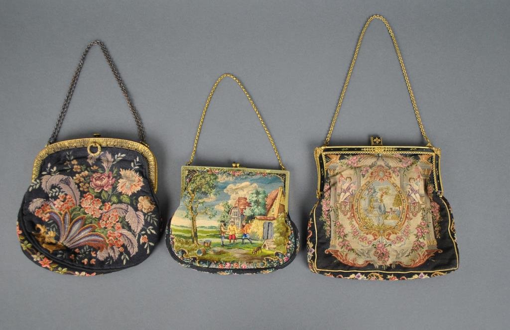 (3) VINTAGE PETIT POINT TAPESTRY BAGS: in floral and scenic motifs, one with sapphire clasp, all with gilt metal frames, one frame in enameling and marcasites (marcasite losses), two with stained and torn linings, largest 7in.