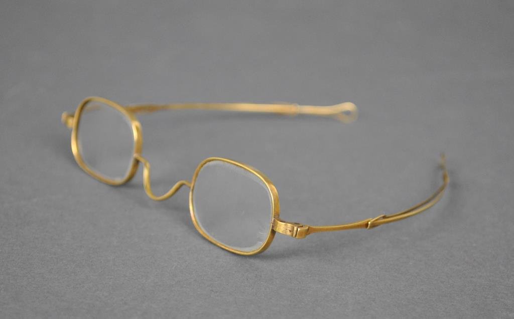 PAIR ANTIQUE YELLOW GOLD SPECTACLES: with sliding adjustable temples, oval lenses, tests14K, gross weight 15.1gms.