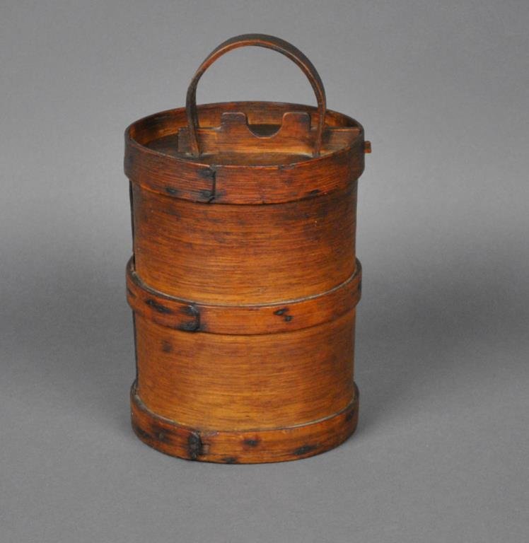 DRUM-FORM BENTWOOD COVERED BAND BOX: tacked lap joints and bands, fitted locking lid with bentwood handle, unusual sliding lock, 12x6.5in.