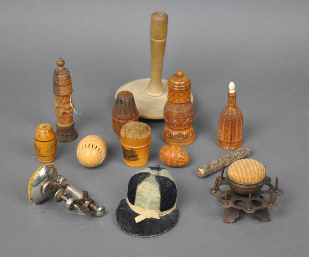 (13) VINTAGE SEWING ITEMS: including 4 carved coquilla nut boxes, 2 highly carved wood spool boxes, a German turned thread box, a filigreed copper needle case, a large wooden darner, and 4 pin cushions including a hat, an eight