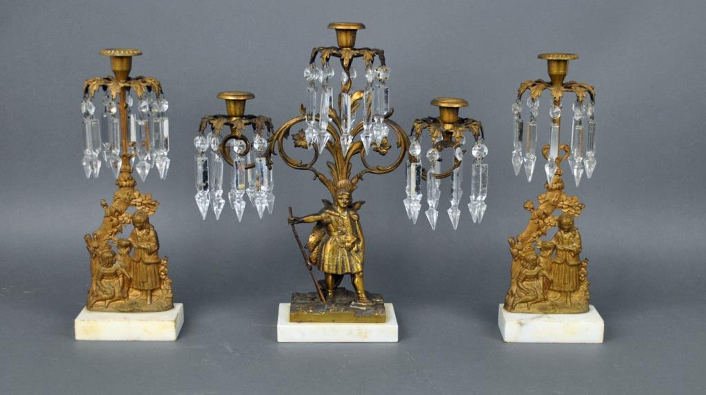 (3) PIECE BRASS & CRYSTAL GIRANDOLE GROUP: the centerpiece with standing native American holding spear, the sides with ‘Mary Had a Little Lamp’ figures, missing 1 prism, tallest 16in.