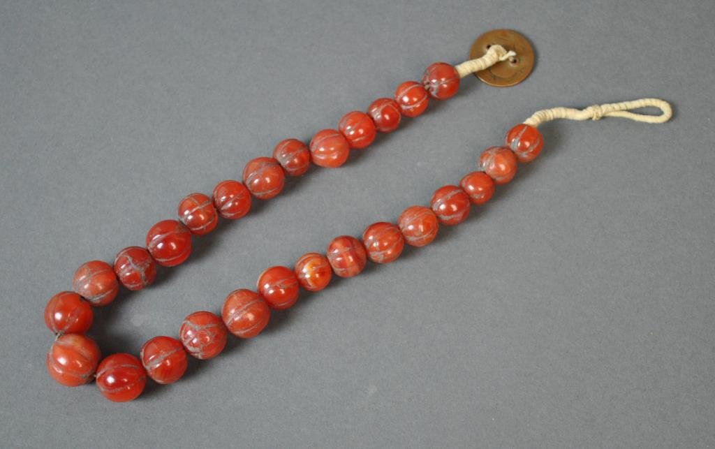 ANTIQUE CHINESE CARVED CARNELIAN AGATE MELON BEADS: composed of 27 graduated beads approx. 14-19mm, on cord with antique coin clasp, 18in., Estate Collection