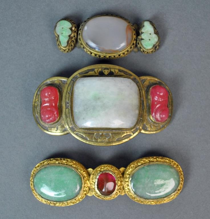 (3) CHINESE JADEITE & AGATE BUCKLE & BUCKLE PARTS: including a belt buckle set with a center jadeite stone approx. 1.25x1.75in., bordered by bat motifs, flanked by 2 carved tourmaline color stones, overall 3.75x3in.; a jadeite buckle with center tourm