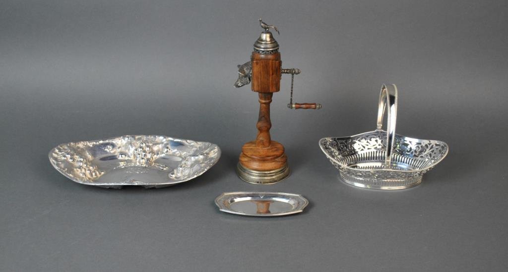(4) PIECE SILVER GROUP: sterling pieces include a Mauser grape repousse bread tray, a pin tray, and a swing arm basket, and a music box grinder with base stamped 800, boar, pheasant finial and handle test silver (pheasant le