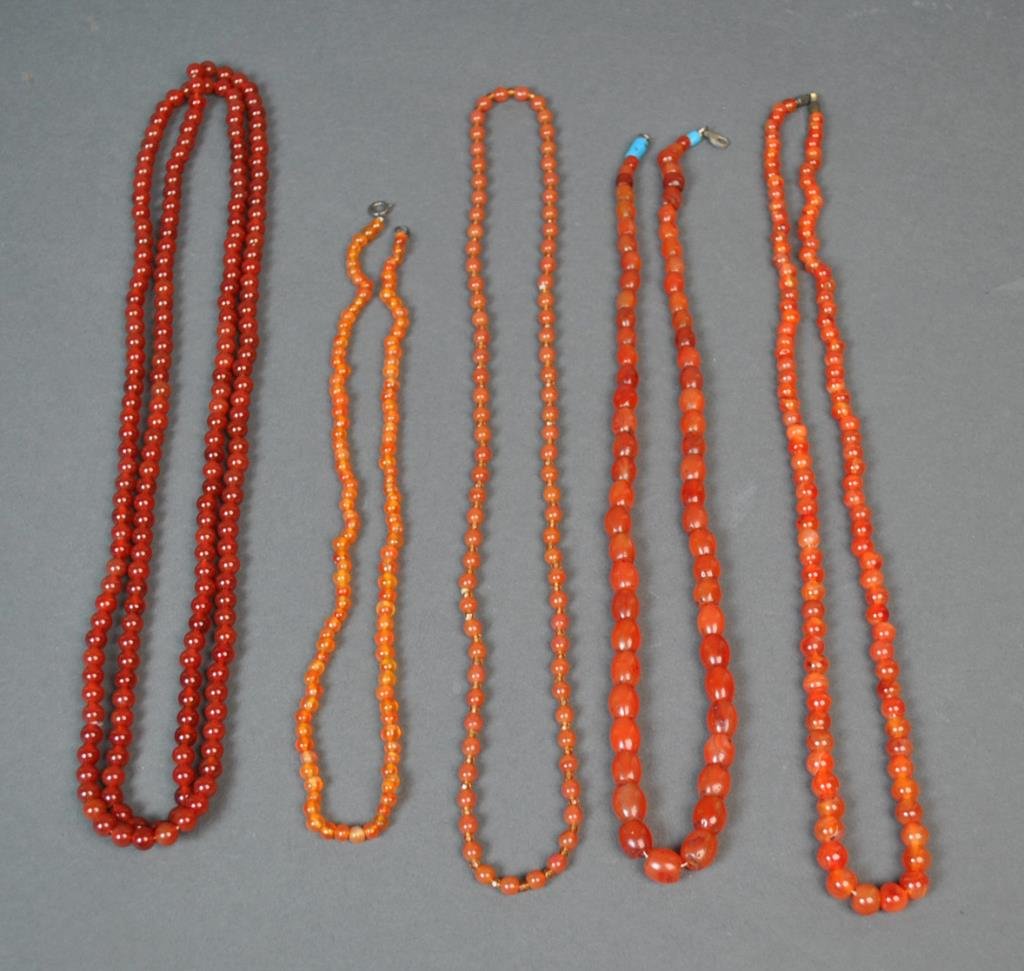 (5) CARNELIAN BEADED NECKLACES: beads range from 5-10mm, lengths 20-52in.