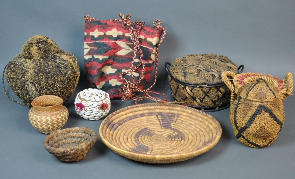 (9) VINTAGE WOVEN BASKETS AND A SALLY BAG: including 4 with covers, a Chinese bamboo basket with seaweed, one with cowry shell decoration, etc., together with a sally bag, possibly African, largest basket diameter 12in.