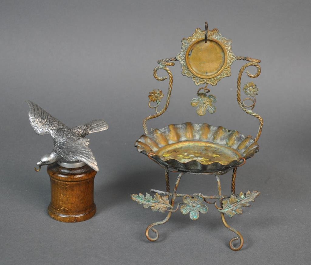 (2) VINTAGE METALWARE POCKET WATCH HOLDERS: including a pewter eagle on wood base with watch hook in beak, signed on verso Eddle Zinn #9623, and a brass wire example with floral painted tole tray, tallest 7.5in.