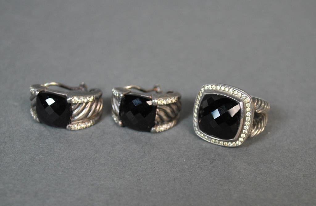 DAVID YURMAN SILVER ONYX & DIAMOND JEWERLY SUITE: comprising a cocktail ring set with a faceted onyx stone (13mm) accented with diamond melee, size 7, and a pair of matching pierced earrings, posts test 14K, 1in., all stamped D.Y. 925
