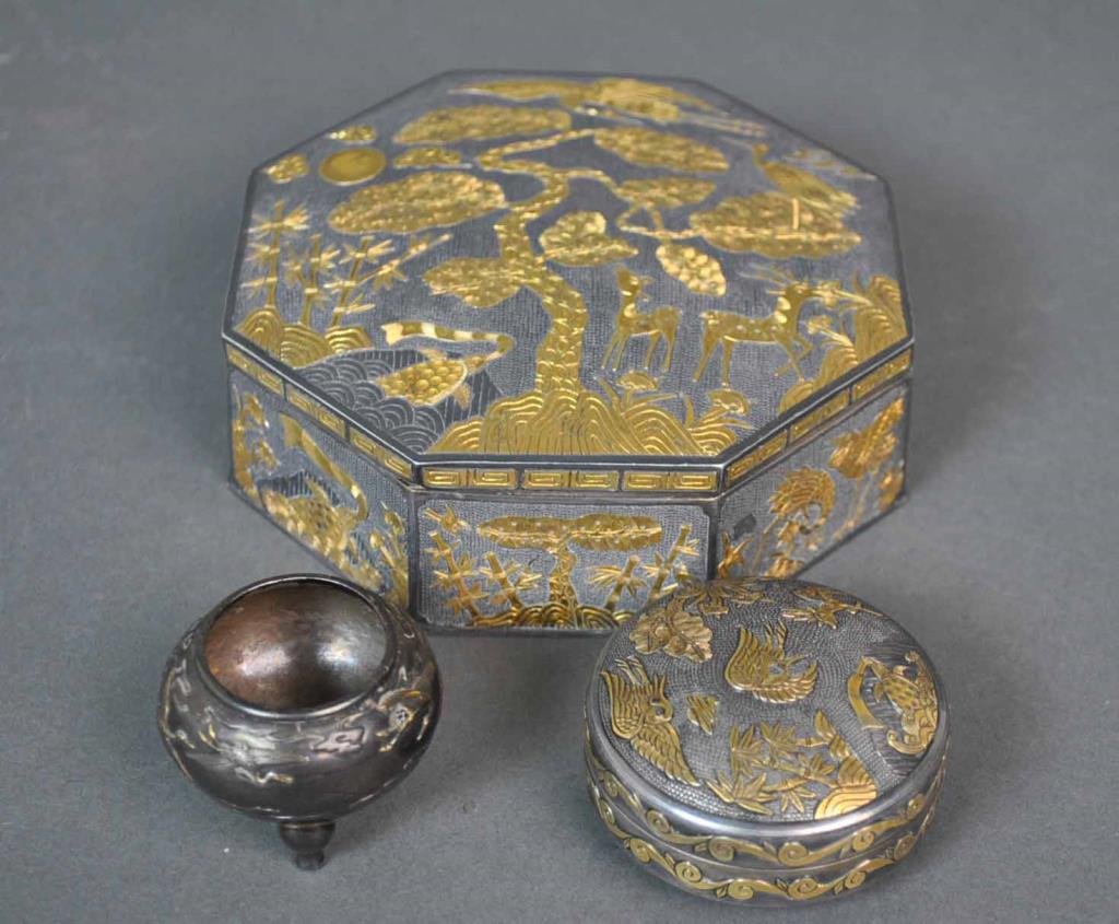 (2) ASIAN SILVER DRESSER BOXES WITH GOLD OVERLAY: depicting animals, bamboo, trees and florals, each stamped 'Silver Gold', and with Asian characters, widest 5in., 25.7ozt., together with a 2.5ozt. Asian footed salt cellar depicting cranes (likely si