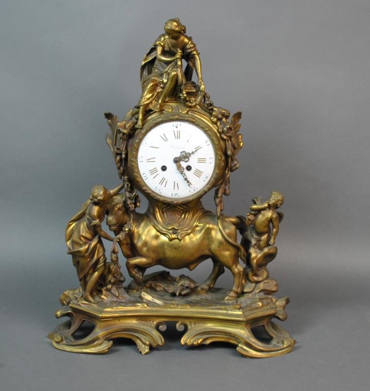 LARGE FRENCH GILT BRONZE FIGURAL CLOCK: 18th/19thC., the casting depicts The Rape of Europa, the face having a circular porcelain dial with Roman hours and Arabic minutes, signed 'Lhuillier A Paris', set in a cartouche-form garland draped c