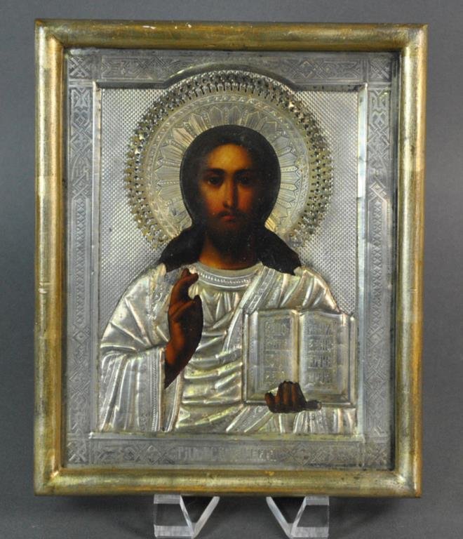 RUSSIAN ICON OF CHRIST PANTOCRATOR, 1900: oil or tempera on panel, overlaid with a silver chased riza, Kokoshnik hallmark, 84 Silver Standard (right side of mark illegible), and with Indistinguishable Cyrillic makers mark, likely turn of the 