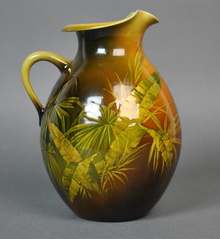 ROOKWOOD PITCHER, KS, 1887: Kataro Shirayamadani, c.1887, in fern frond decoration, marks include single flame logo, mold number 412, and the incised cypher of the artist, small glaze lines or imperfections at rim near spout, 8.
