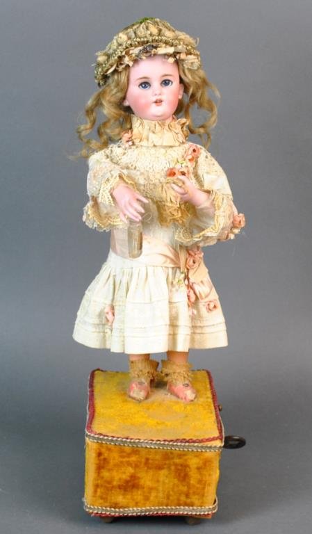SIMON & HALBIG AUTOMATION DOLL: bisque head marked 1300-6 DEP S-H, bisque lower arms, composition legs, key wind mechanism and operating lever, in working condition as dolls head turns from side to side while her right arm raises an