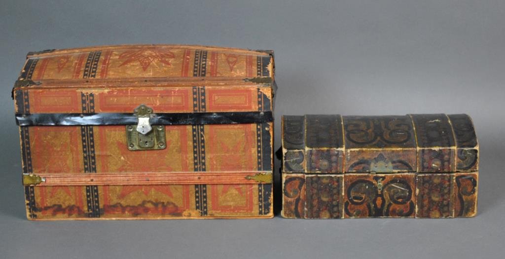 (2) ANTIQUE DOMED DOLL TRUNKS WITH ACCESSORIES: including a larger trunk with interior fitted shelf with covered compartment, 10x16x9in., and a smaller trunk, 5.5x12.5x8in., accessories include 2 dresses, a skirt with matching jacket, a pair of lea