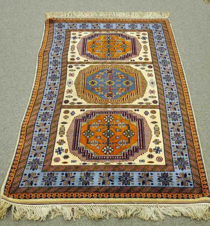 INDIAN WOOL RUG, 5.3 X 3: 20thC., in cream, blue, dark blue, rust and red tones, 2 sewn in hang rings, Made in India label