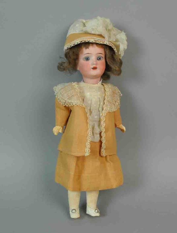11" THEODOR RECKNAGEL 1914 BISQUE HEAD DOLL: socket head, glass eyes, open mouth with teeth, marked '1914 DEP R 7/0 A', appears papier mache body (somewhat loose head stringing), in as-is box doll was found in, 11in., Estate of Yolanda Simonelli