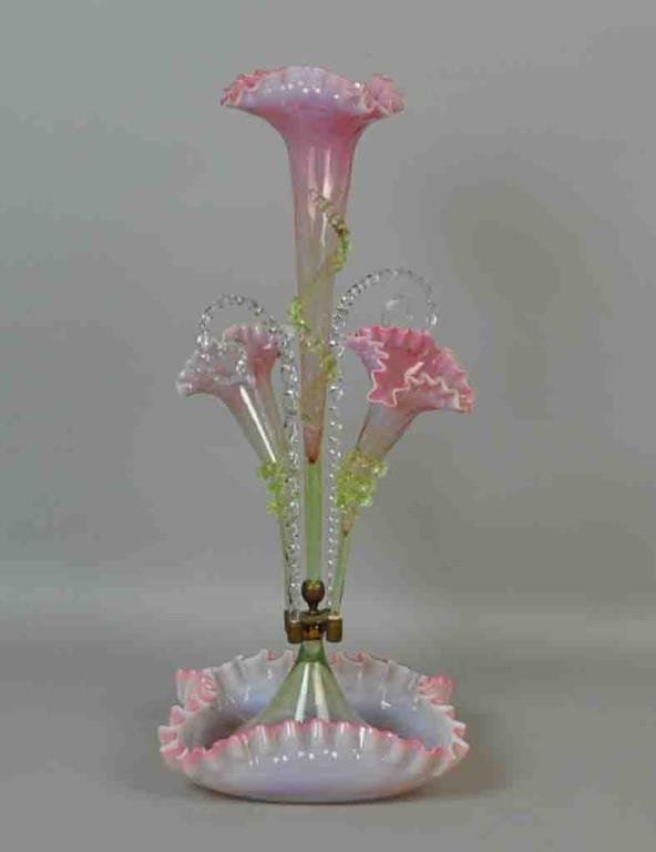 VICTORIAN PINK & OPALESCENT GLASS EPERGNE: three-arm with applied green glass rigaree, two twisted glass rods, ruffled opalescent edges, one minor loss to rigaree wrap, base 12in., overall 22in.