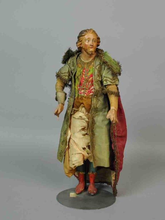 NEOPOLITAN PAINTED TERRACOTTA CRECHE FIGURE: gesso hands, legs and feet, polychrome painted feet and legs, embroidered silk clothes and robes, glass eyes, 12.5in., Estate of Yolanda Simonelli