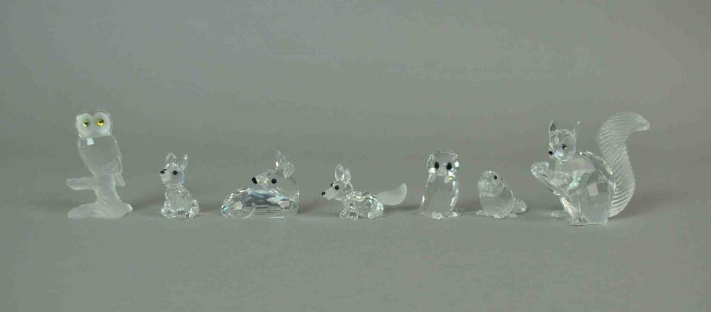 (7) SWAROVSKI FIGURINES - WOODLAND CREATURES: including 10th anniversary squirrel, mini running fox, mini sitting fox, roe deer fawn, sitting baby beaver, owl, and owlet, all in original boxes, tallest 2.25in.