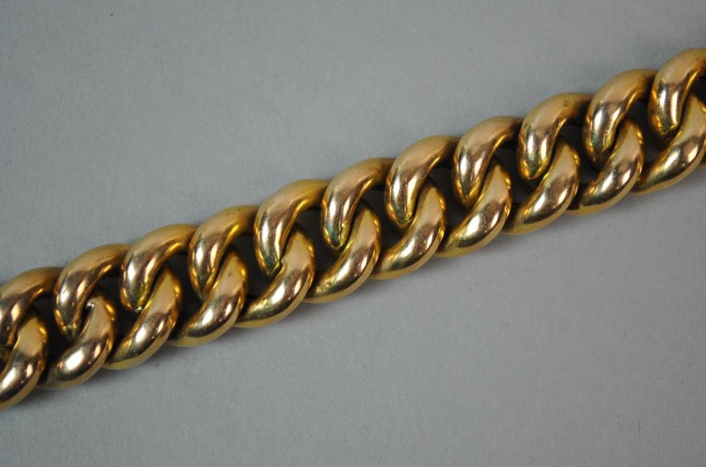 18K HEAVY CURB LINK BRACELET: stamped 18KAR, safety catch, (bale link present for safety chain, chain missing), height .5in., length 8in., 53.2gms.