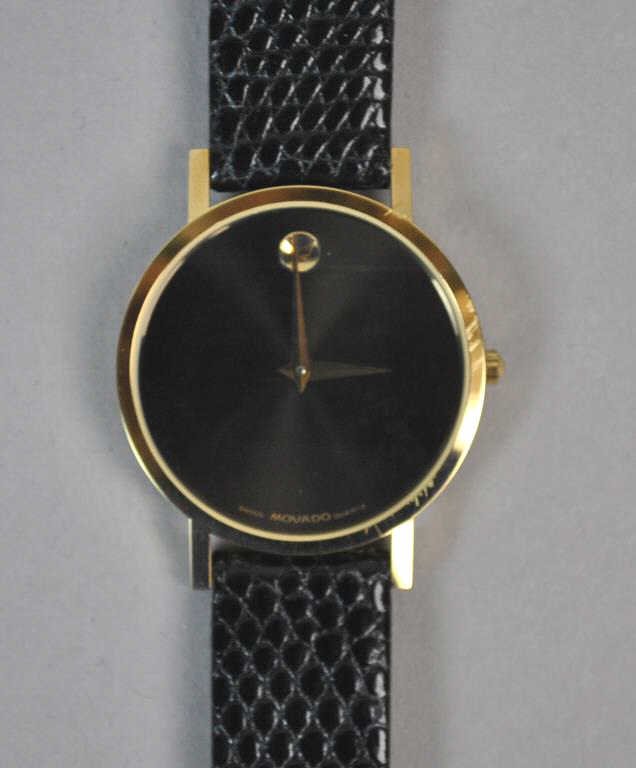 MOVADO WATCH: MOVADO WATCH dial marked 'Swiss Movado Quartz', band stamped 'Genuine Lizard Movado Swiss' (non-running, likely needs battery), 9in.