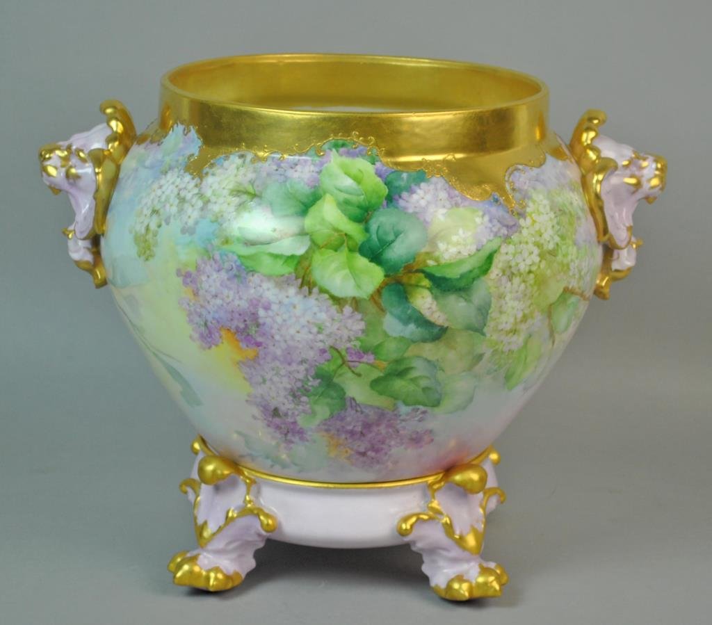 LIMOGES LILAC JARDINIERE ON STAND: heavily gilt collar, lion head handles, the base paw feet, D & C France mark for Delinieres & Co., 11.5x14in.