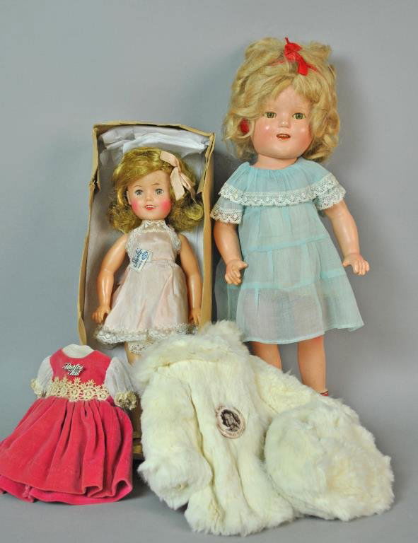 (2) SHIRLEY TEMPLE DOLLS: including a 15” composition doll marked ‘Shirley Temple Ideal’, sleep eyes, open mouth with teeth (age wear, staining, crazing, loose stringing), and a 12” vinyl doll with an original slip, ma