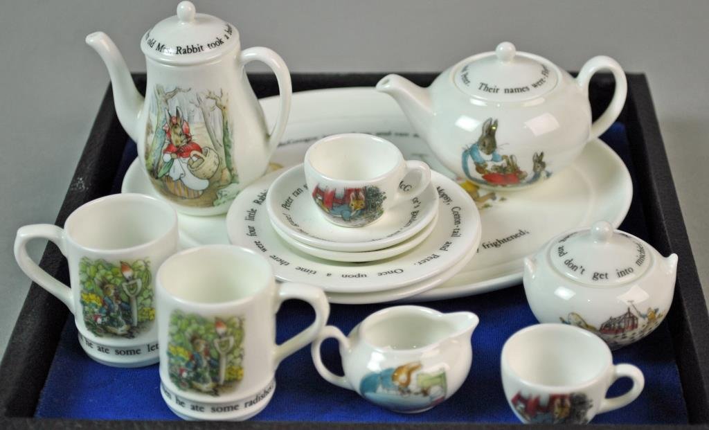 (13) PIECE WEDGWOOD MINIATURE TEA SERVICE: bone china, in Peter Rabbit pattern, includes 2 each coffee cups, lunch plates, teacups and saucers, a 6.5" oval tray, teapot, coffee pot, creamer and covered sugar