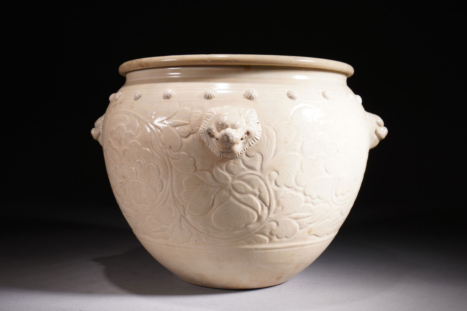 A white-glazed animal's head and floral drum-nailed jar: A white-glazed animal's head and floral drum-nailed jarpaid in boxes