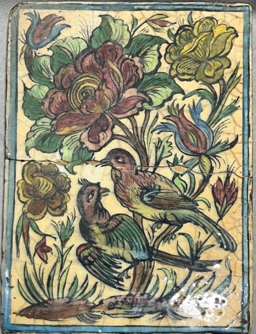 UNTITLED | UNDERGLAZE-PAINTED EARTHENWARE (CERAMIC) | QAJAR DYNASTY, 19TH CENTURY: A 19TH-CENTURY PERSIAN QAJAR DYNASTY MOLDED POTTERY TILE DECORATED IN POLYCHROME UNDERGLAZE. THE CENTRAL MOTIF DEPICTS THE CLASSIC 'GOL-O-BOLBOL' (ROSE AND NIGHTINGALE) SCENE WITH TWO BIRDS PERCHED