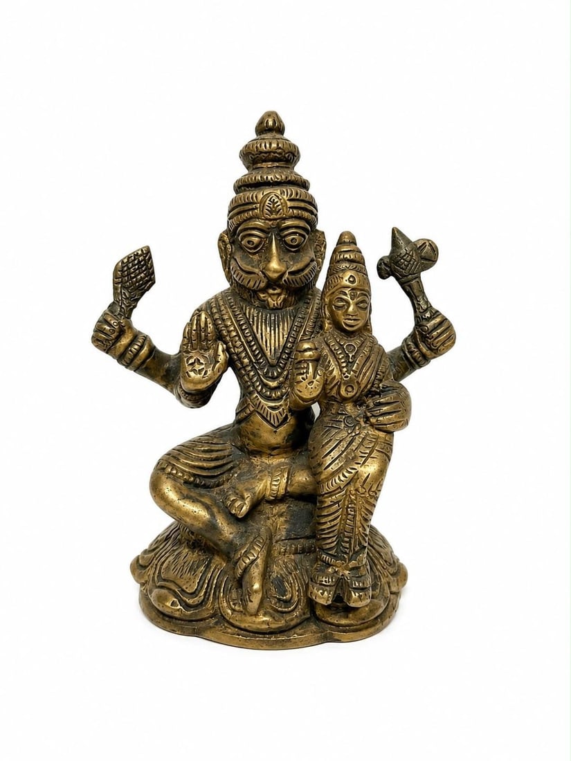 LAKSHMI NARASIMHA BRASS STATUE | LATE 20TH CENTURY | BRASS: A TRADITIONAL INDIAN BRASS SCULPTURE DEPICTING LORD NARASIMHA, THE LION-HEADED FOURTH AVATAR OF LORD VISHNU, SEATED WITH HIS CONSORT GODDESS LAKSHMI ON HIS LEFT LAP. NARASIMHA IS RENDERED WITH FOUR