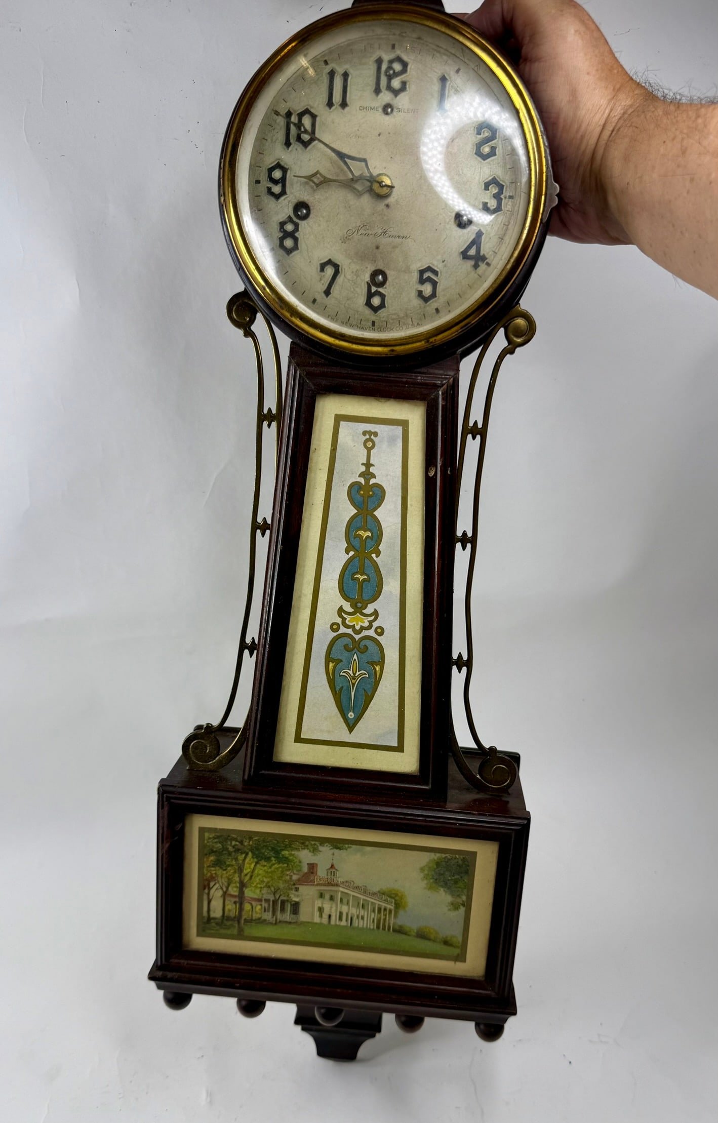 New Haven Banjo Clock Ca 1920: This is a New Haven banjo clock with an 8 day wind up movement that strikes the hour, quarter and half hours.