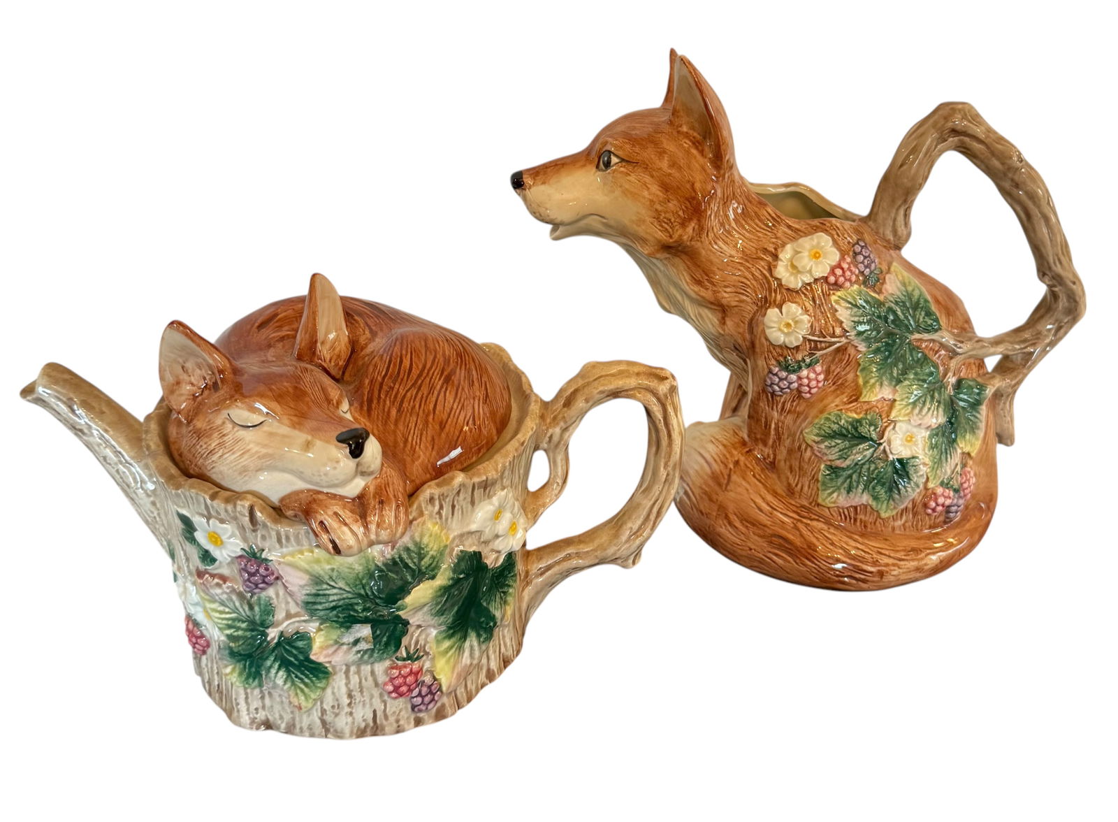 Fitz and Floyd Fox Teapot and Pitcher: Fox motif with blooming berries on teapot and pitcher. Two pieces. Teapot 11.5W x 7"D x 6"H. Pitcher 9.5"H x 12"W x 7.5" D.
