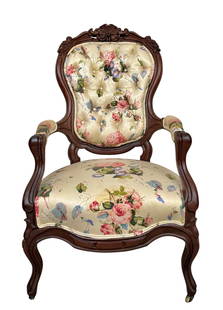 Rococo Revival Carved Walnut Arm Chair Attributed to Mitchell and Rammelsberg: American, mid 19th century. A Rococo Revival walnut arm chair; the shield-form back having a crest rail elaborately carved with fruit and foliate detail, the front rail having applied panels, and cabr