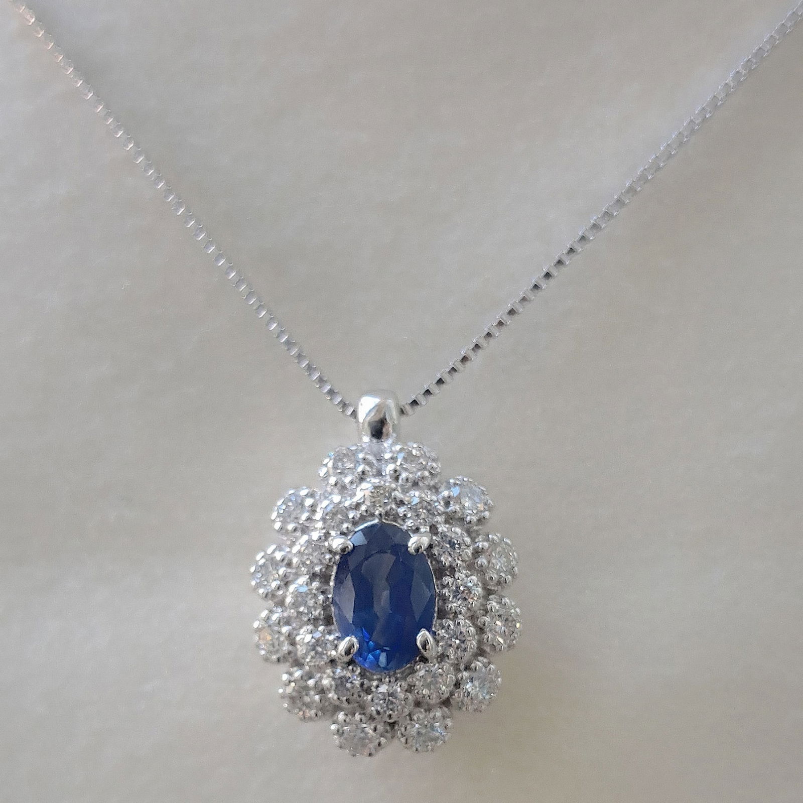 A 0.50ct Sapphire is set on a 18k Solid White Gold 3.3g Pendant Necklace, full of 0.35ct Diamonds (1 of 2)