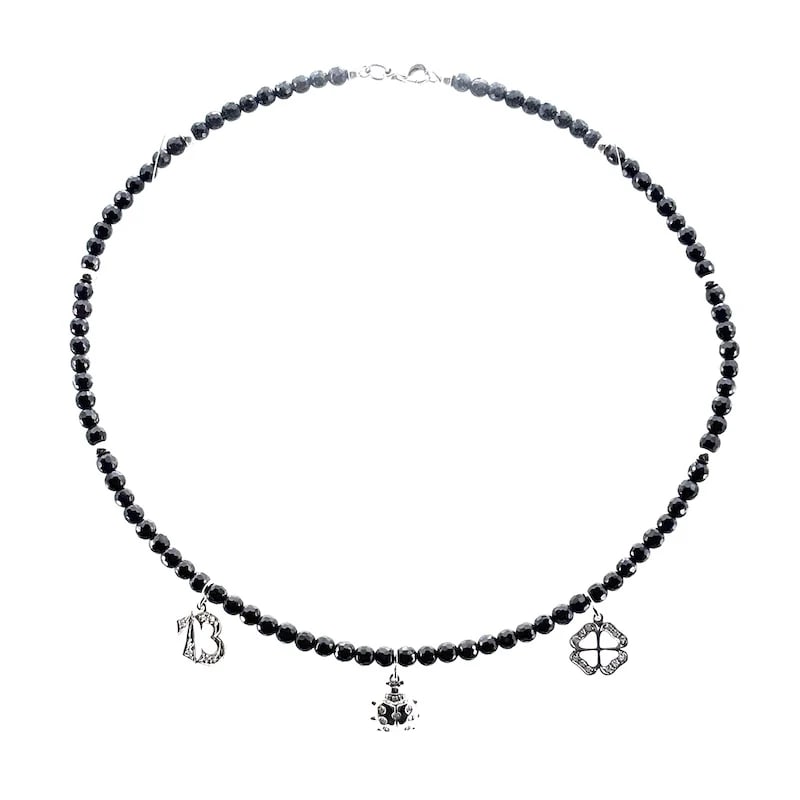 Semi-rigid choker made of 18k white gold and onyx faceted beads with diamond charms ? 14.49gr: Semi-rigid choker necklace crafted in 18K white gold, featuring faceted onyx beads accented by polished gold spacers, clasp, and luck charms. Weight: 14.49 gr Length 15.74" Diamonds weigh 0.19-0.23ct