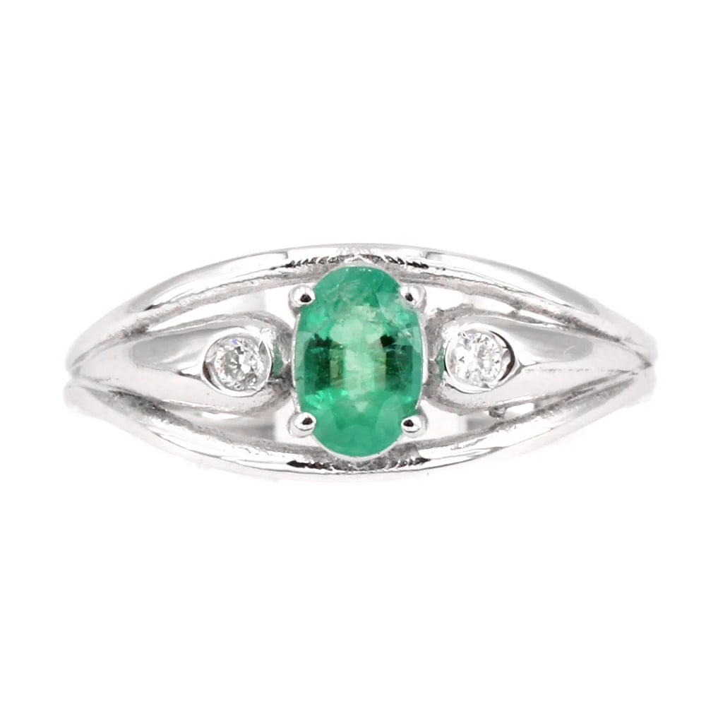 A Timeless 0.44ct Emerald is set on this 18K White Gold Band Ring with 0.04ct Side Diamonds, 2.28 gr: A Timeless 0.44ct Emerald is set on this 18K White Gold Band Ring with 0.04ct Side Diamonds. A sleek and stylish design offering a striking balance of elegance and value. Weight: 2.28 gr Ring Size: US